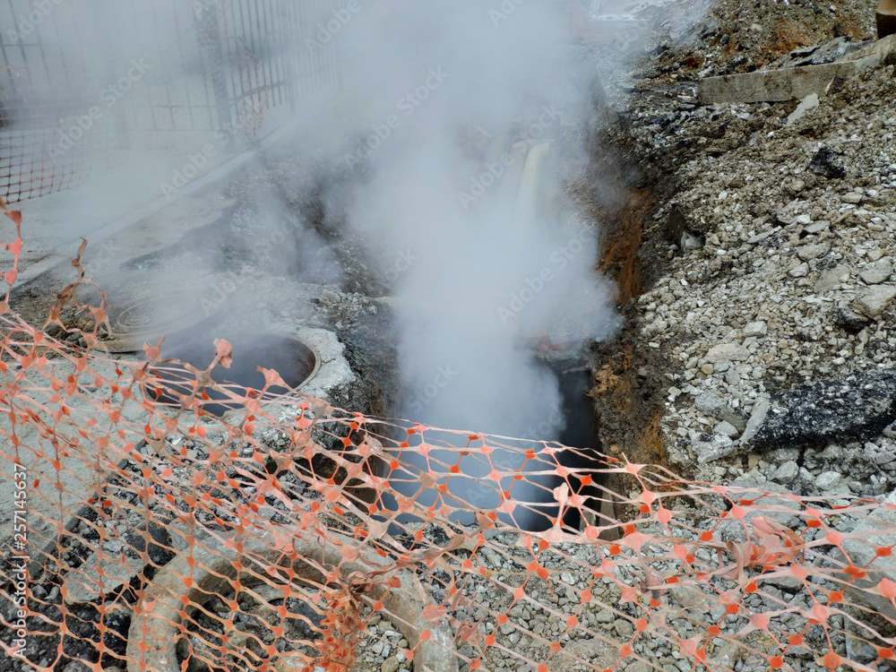 Excavated underground pipeline with a breakthrough and steam