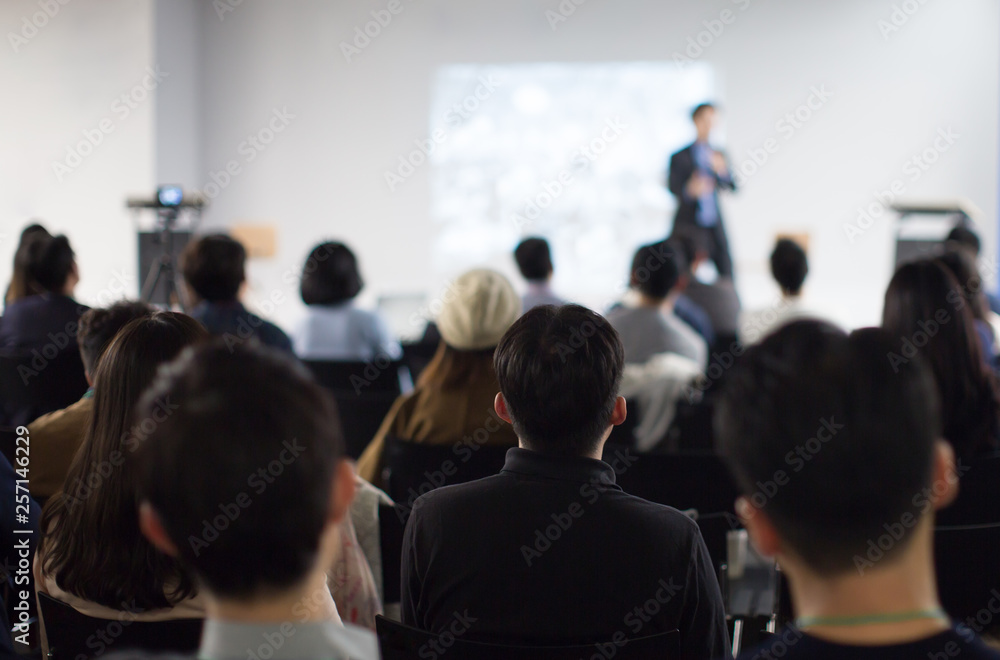 Conference Photo with Audience. Business Crowd and Executive Speaker on Stage. Business Presentation Presenter Speech at Meeting. Corporate Event with Audience. Expert Seminar Lecture Conference Event
