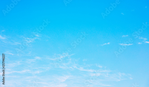 Blue sky background and white clouds soft focus, and copy space