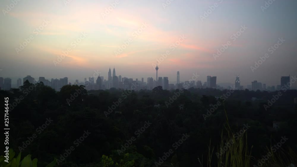 4k UHD establishing cinematic b-roll shot of sunrise scene at Kuala Lumpur city skyline during hazy and misty season.