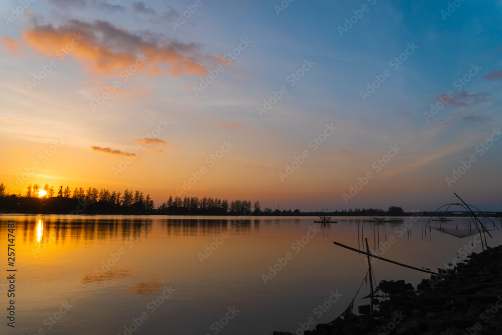 View of waterproof dam with sunset sky background. View of waterproof dam with sunset sky background.