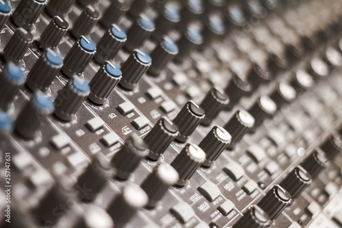 Macro Diagonal detail of analog studio knobs mixer