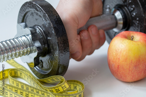 dumbbell Apple hand and meter the concept of a healthy lifestyle