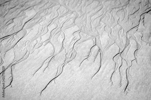 Beautiful shapes formed by the water on the surface of the sand