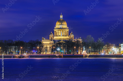 Neva river under the ice and snow and Beautiful Saint Isaac's Cathedral or Isaakievskiy Sobor in Saint Petersburg, Russia in the cold winter evening or night