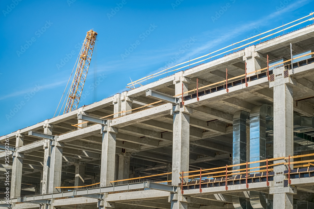 concrete bulding in construction and yellow crane concrete bulding in construction and yellow crane