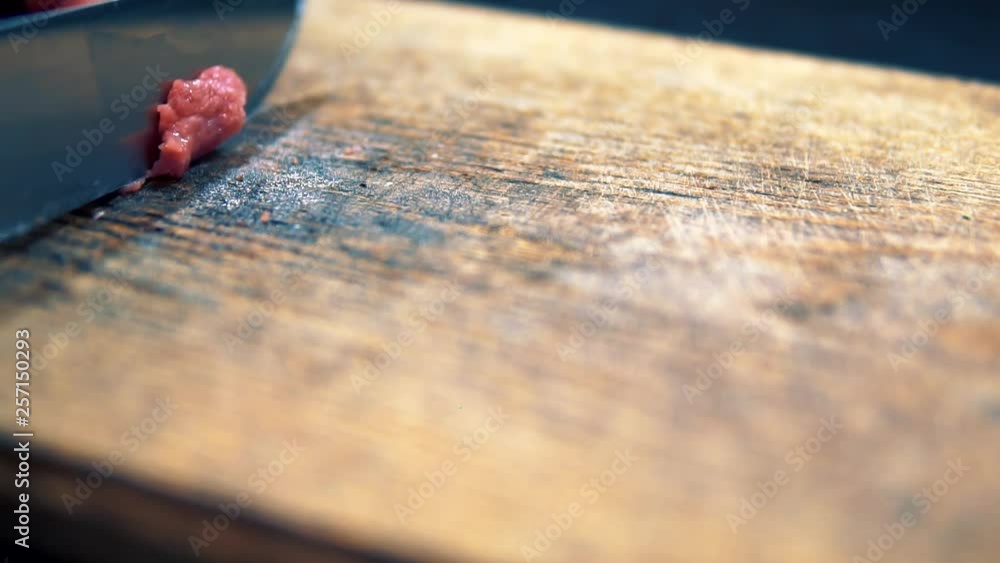 Cutting Meat Into Small Pieces On Wooden Table.Slicing Small Raw Piece Of Meat.Cook Cuts Beef Meeat In Small Pieces.Slicing Meat Into Small Pieces On Cutting Board, Close Up.Man Slicing Raw Meat. Cutting Meat Into Small Pieces On Wooden Table.Slicing Small Raw Piece Of Meat.Cook Cuts Beef Meeat In Small Pieces.Slicing Meat Into Small Pieces On Cutting Board, Close Up.Man Slicing Raw Meat.