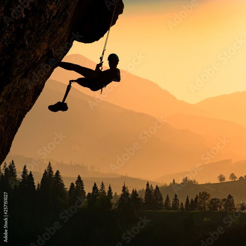 Silhouette of climber with prothesis