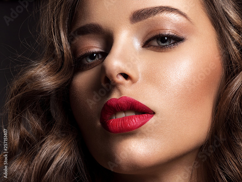 Beautiful face of young woman with red lipstick.