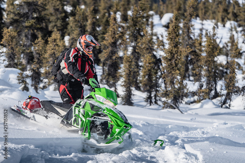 Rider on snowmachine riding Arctic Cat Sled