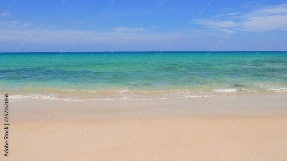 Wide angle view of waves at a pristine blue beach during daytime Wide angle view of waves at a pristine blue beach during daytime