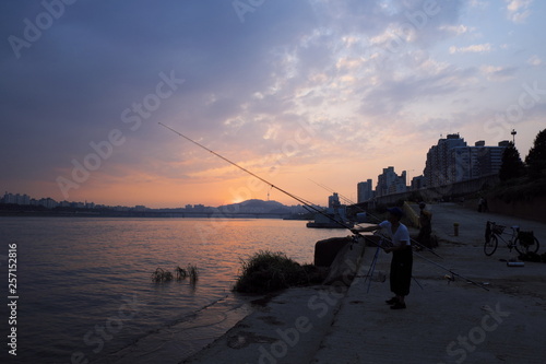 sunset on river with fisher