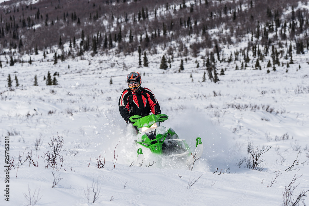 Rider on snowmachine riding Arctic Cat Sled