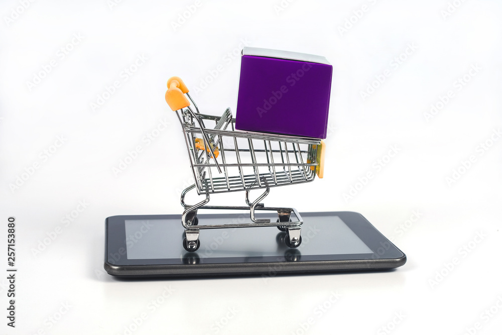 Shopping cart or metal trolley on mobile tablet for Online shopping and ecommerce. Shopping cart or metal trolley on mobile tablet for Online shopping and ecommerce.