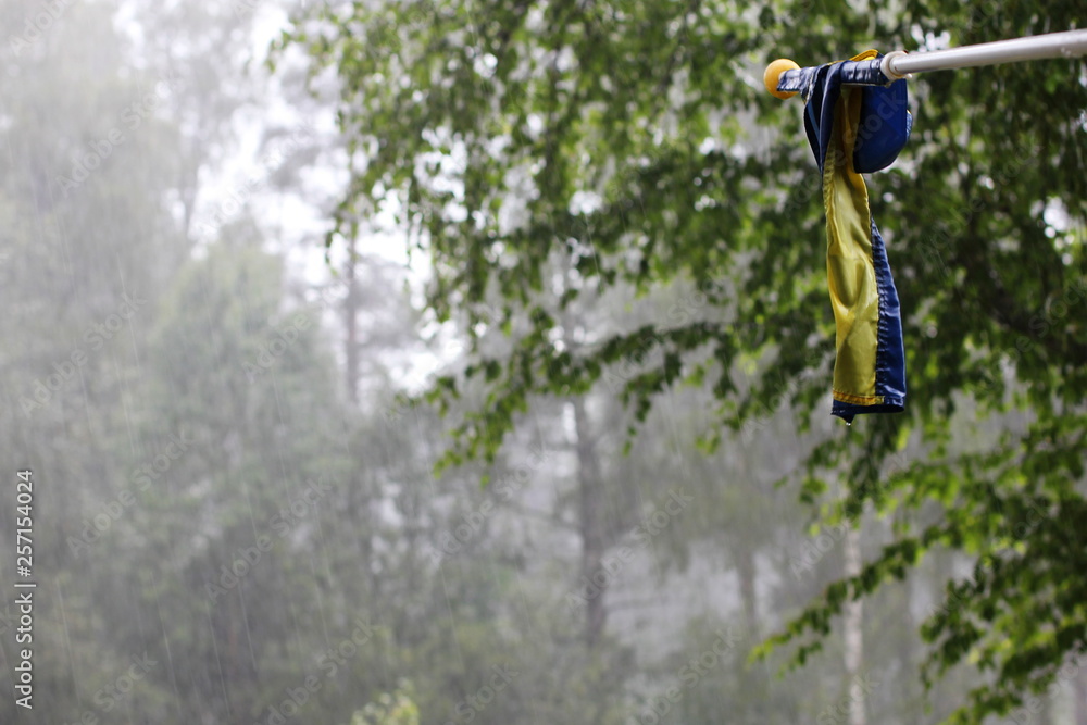 A very wet swedish flag in a rainy summer A very wet swedish flag in a rainy summer