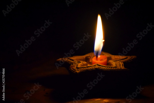 Canvas Print burning candle on black background in india diwali festival