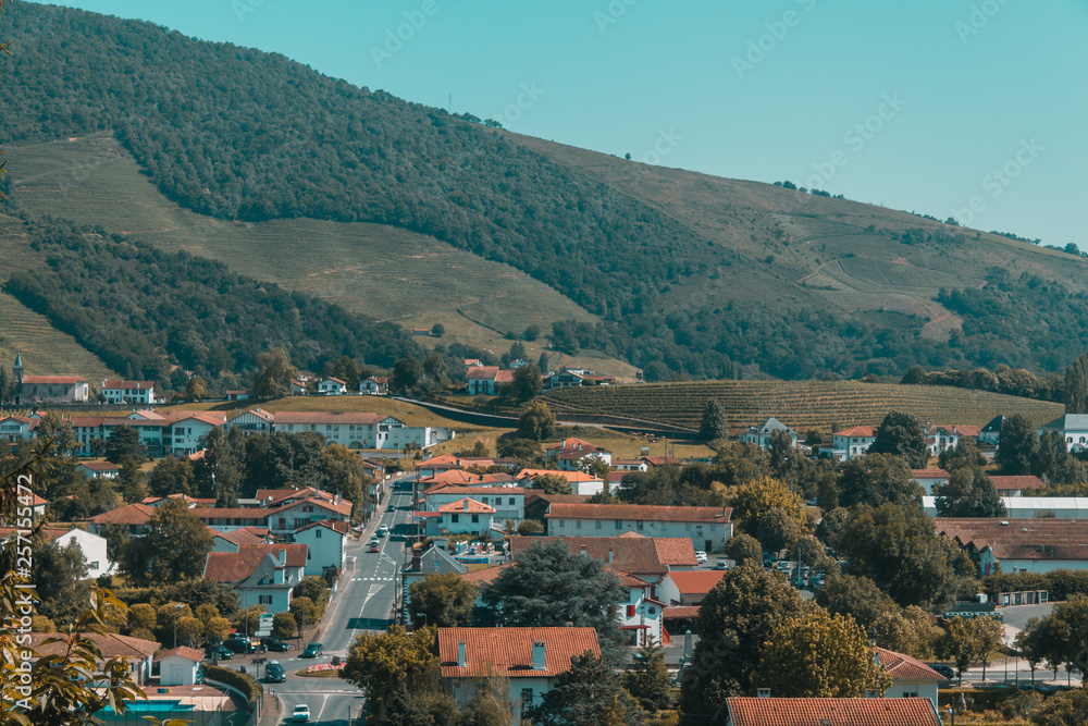 Town of Saint-Jean-Pied-de-Port under hills and blue sky in the Basque Country of France