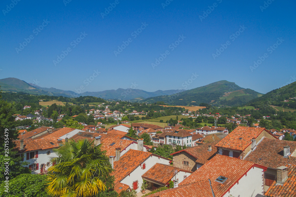 Town of Saint-Jean-Pied-de-Port under hills and blue sky in the Basque Country of France
