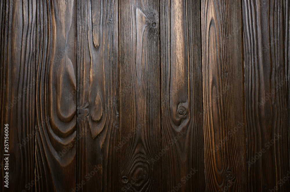 Natural dark wooden textured background of flat layed planks with weathered vintage oiled surface