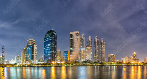 Panorama Modern buildings and business district cityscape from urban park night view cityscape image of Benchakitti Park Bangkok Thailand