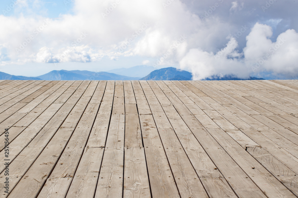 wooden desk space, clouds and mountains. spring wooden desk space, clouds and mountains. spring