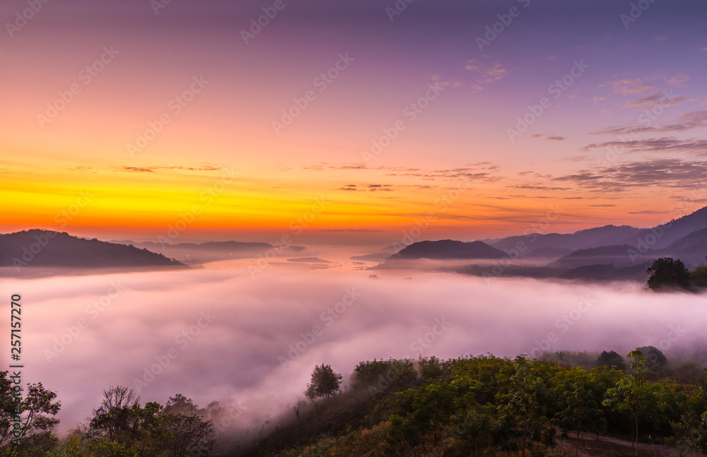Fototapeta premium Viewpoint of the sea mist over the Mekong Rive in Laos and beautiful sunrise viewpoint,nature,travel at Phu Huay Isan,Nong Khai,Thailand