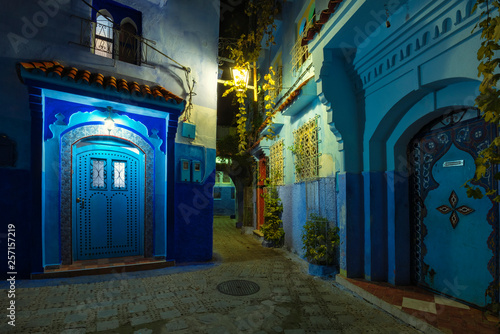 Fantastic night view at traditional moroccan architectural details.  Blue street walls of the popular city of Morocco, Chefchaouen. Chefchaouen is a religious blue town among the mountains.  © dsaprin