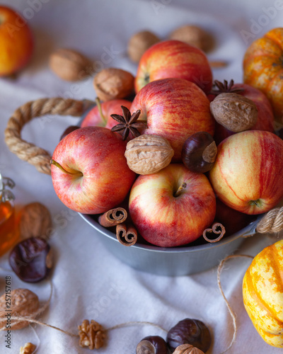 Seasonal autumn still life with apples, nuts, spices. decorated in rustic style. bright colors, ripe and fresh fruits