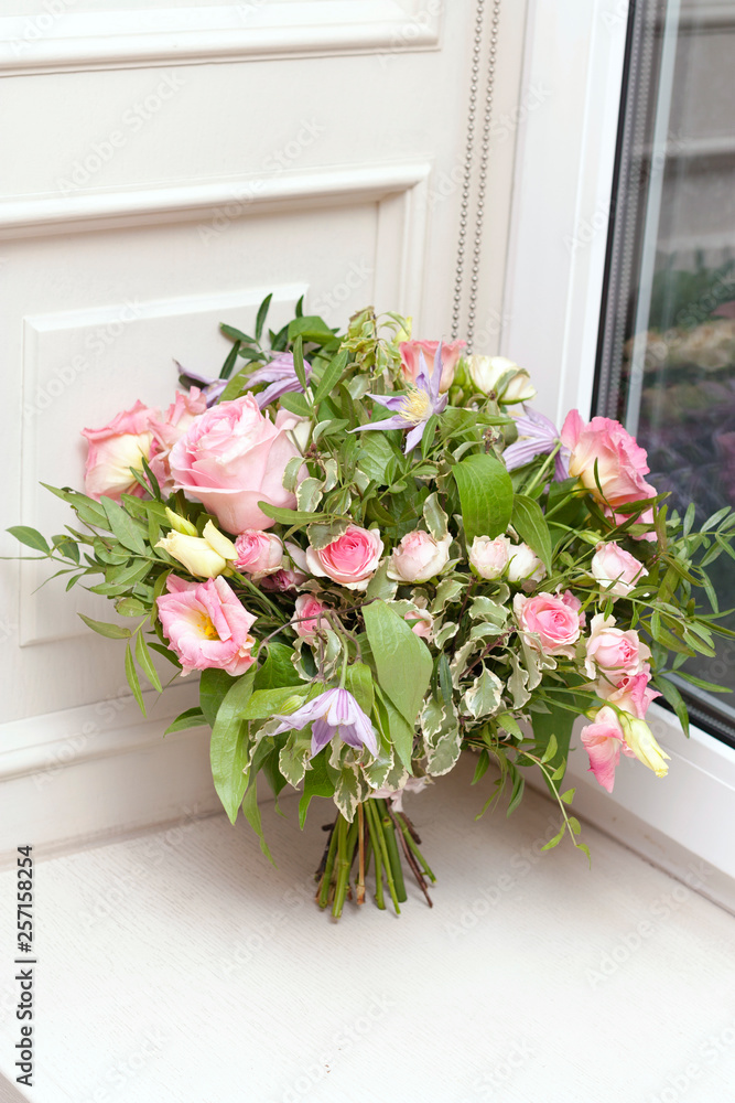 Wedding bouquet is at the window. Bouquet of pink flowers Wedding bouquet is at the window. Bouquet of pink flowers