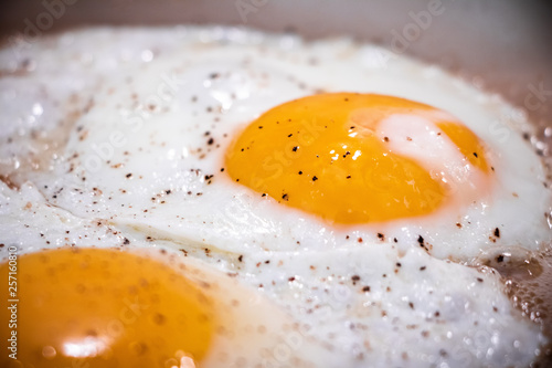 Closeup view of fried eggs on pan