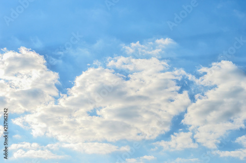 Picturesque white clouds against the textured blue sky. Natural background