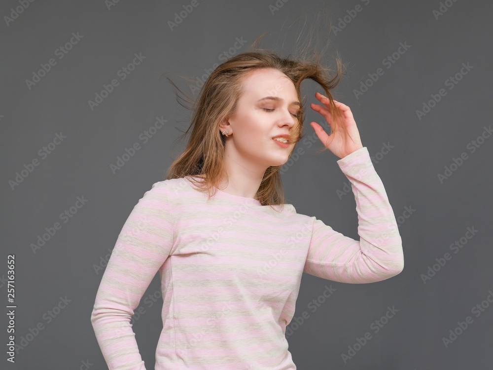 portrait of soncept young cheerful long-haired brunette woman standing in casual clothes, shaking hair and talking. portrait of soncept young cheerful long-haired brunette woman standing in casual clothes, shaking hair and talking.