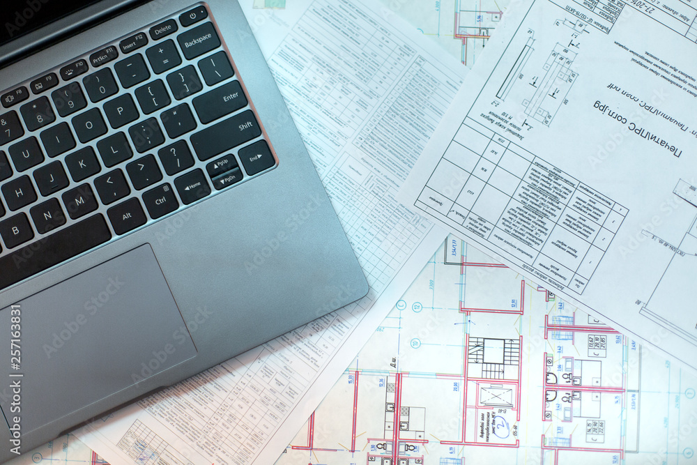 Pencil and computer laptop on architectural drawing paper for construction Pencil and computer laptop on architectural drawing paper for construction