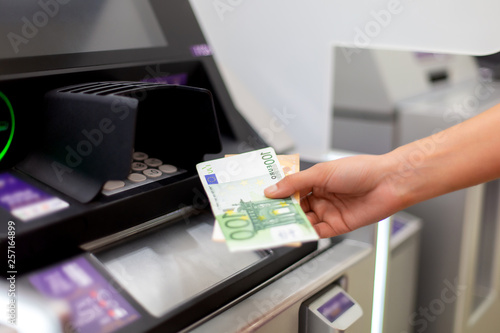 A bundle of money from one hundred euros. Women's hands hold money denominations of 100 euros. Cash out money at an ATM