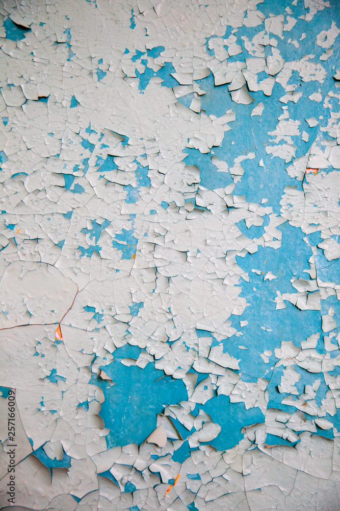 Aged wall plaster blue and white rough surface, grunge texture of the wall old paint