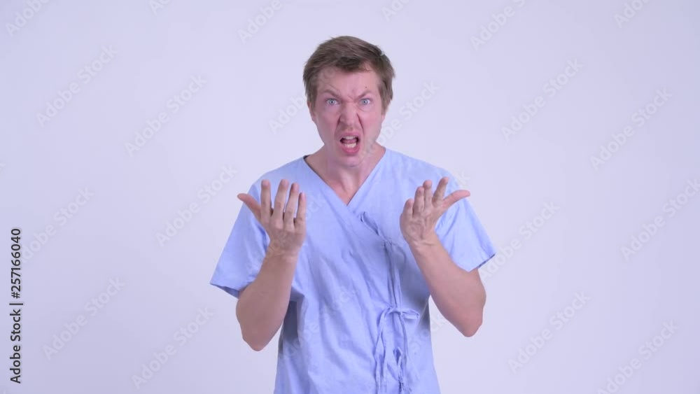 Young man patient covering mouth and looking shocked Young man patient covering mouth and looking shocked