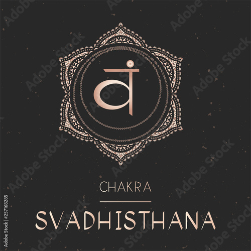 Vector illustration with gold symbol chakra Svadhishana on dark background.