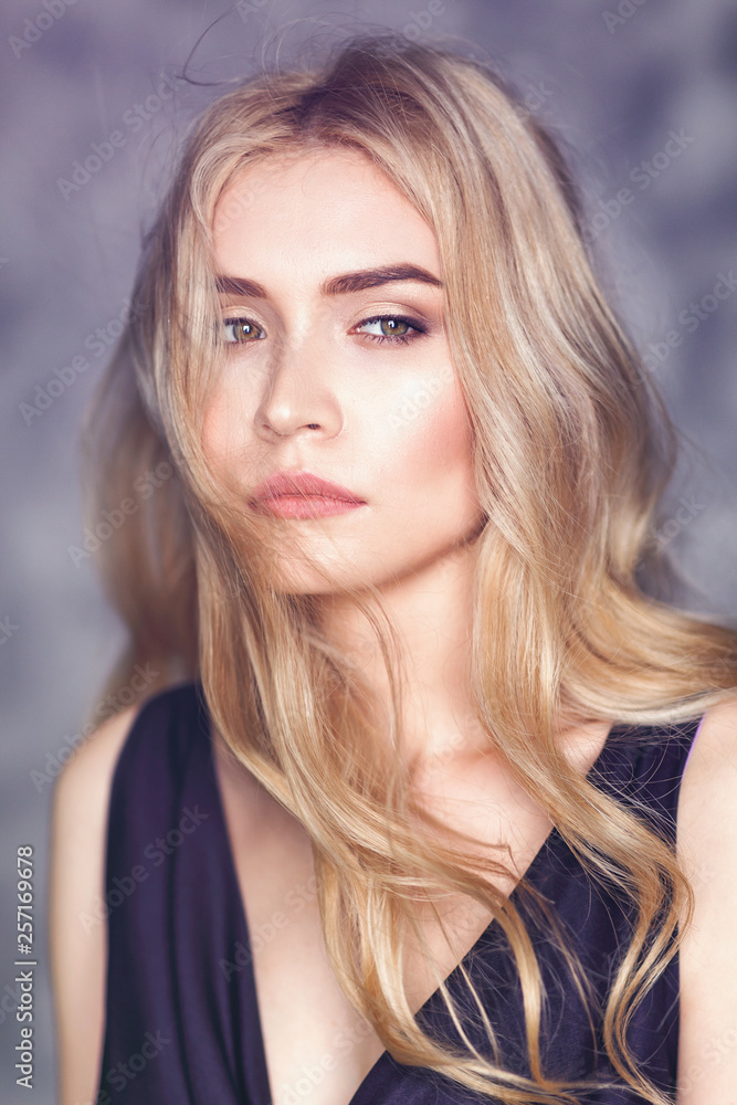 Fototapeta premium Portrait of a young beautiful girl with a pensive look, closeup