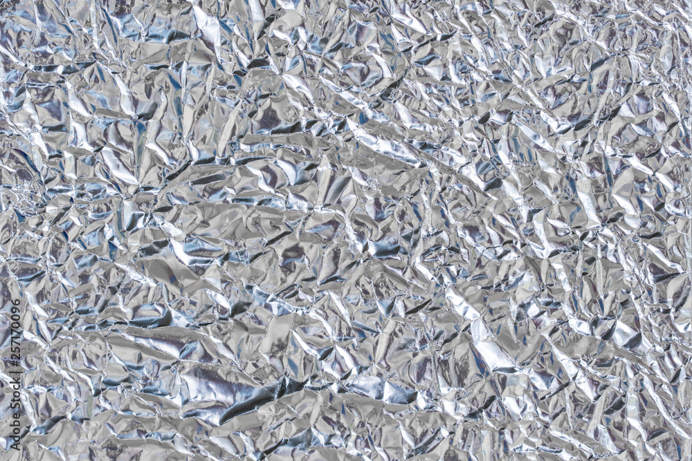 Shiny metal silver foil texture and uneven surface for background Shiny metal silver foil texture and uneven surface for background