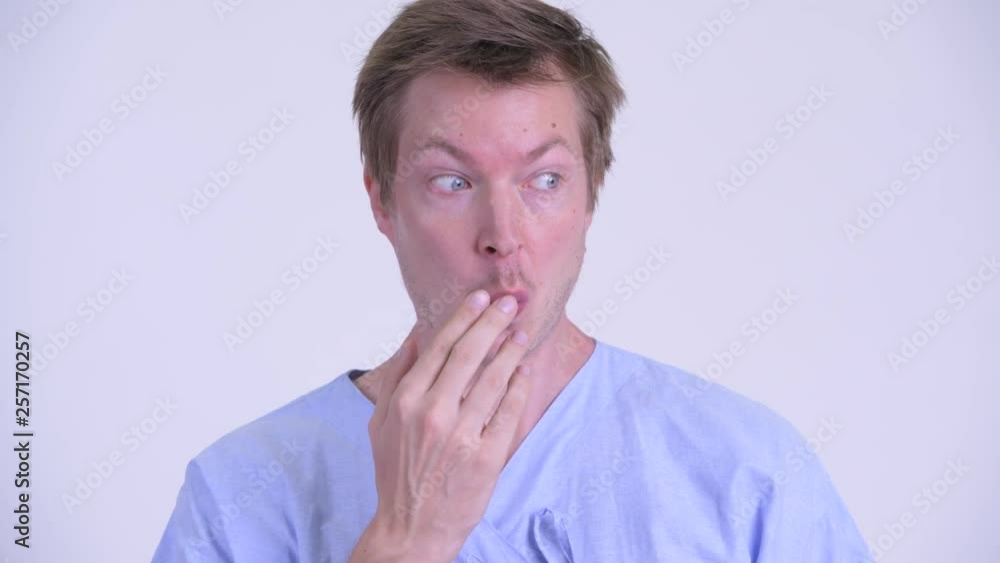 Face of young man patient covering mouth and looking guilty Face of young man patient covering mouth and looking guilty
