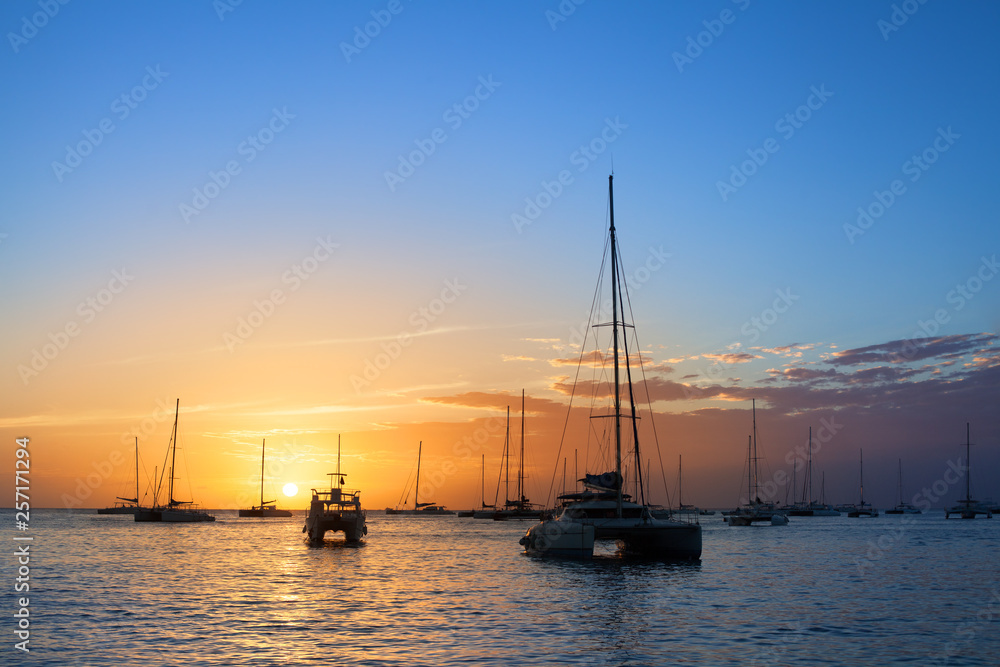 Beautiful sunset on the sea beach, boats, ships and yachts on water background