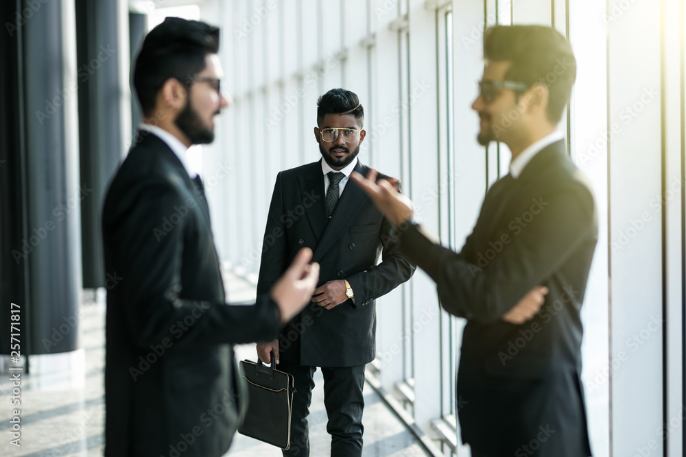 Two businessmen discussing at office during business meeting in front of business partner before decision. Two businessmen discussing at office during business meeting in front of business partner before decision.