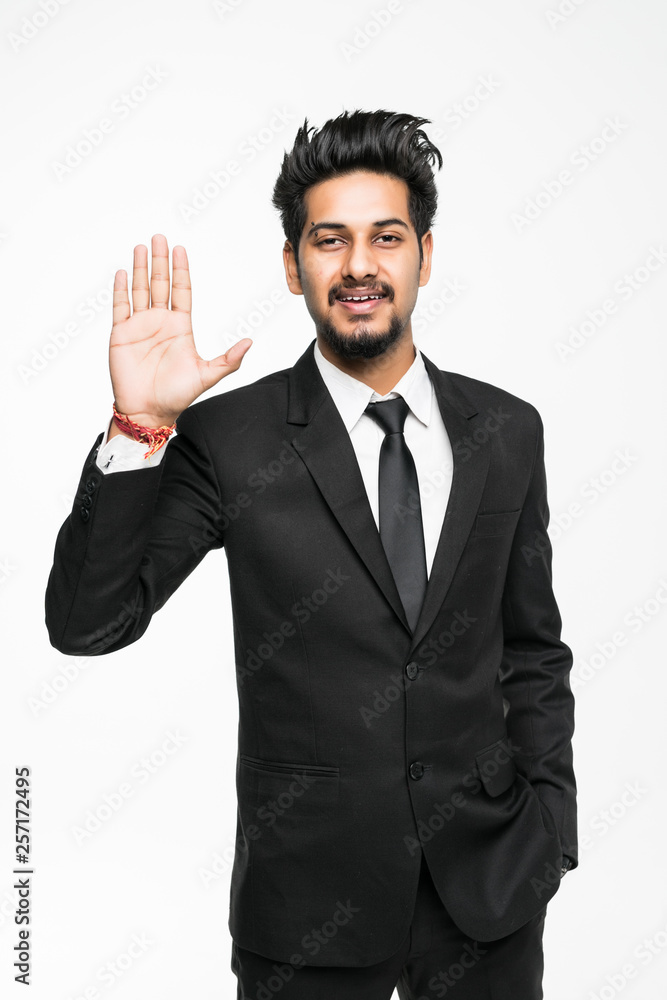 Young indian businessman shows his hand hello isolated on white background. Young indian businessman shows his hand hello isolated on white background.
