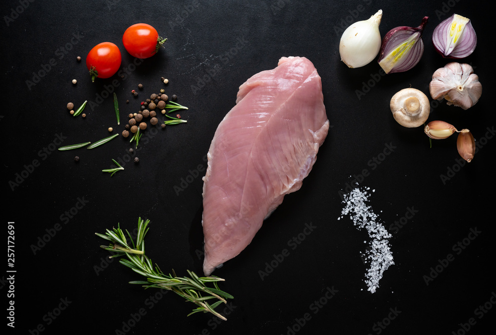 Raw chicken breast with herbs and spices