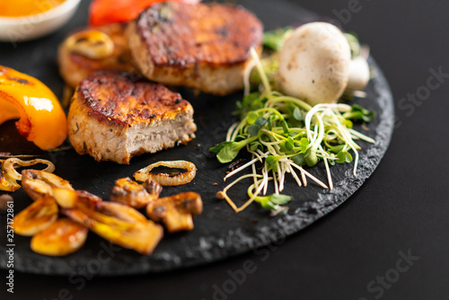 Grilled garlic cloves with sprouts and pork fillet