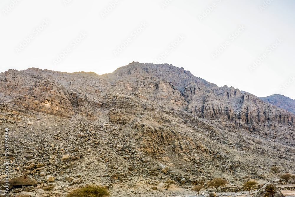 Fototapeta premium Geological landscape of Jabal Jais characterised by dry and rocky mountains, Mud Mountains in Ras Al Khaimah, United Arab Emirates