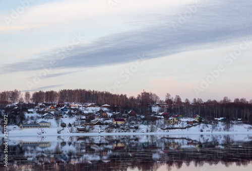 winter village reflection in the river © korolev
