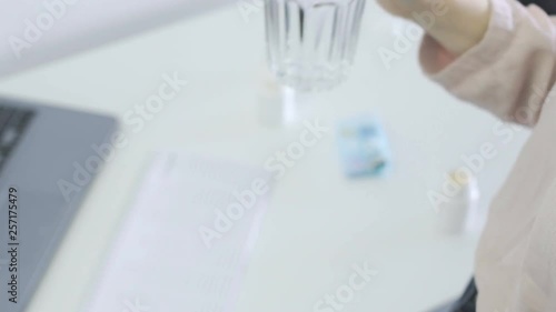 Wallpaper Mural Woman swallowing a pill with water. Desktop on the background Torontodigital.ca