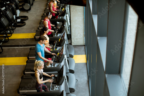 Top view at young people running on treadmills in modern gym