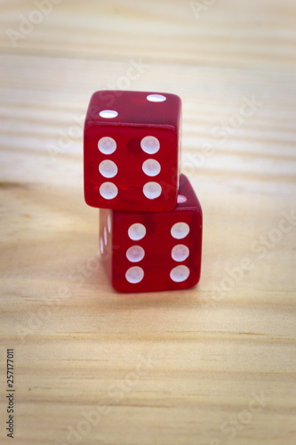 Red dice isolated on a wood background doublets 6 stacked photo